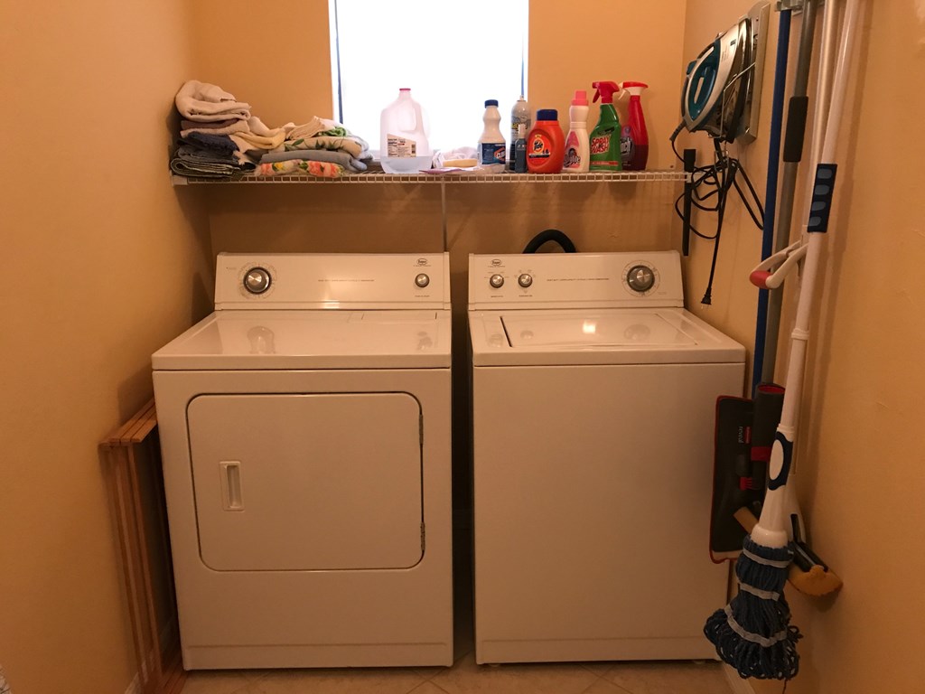A white washer and dryer in a small laundry room.