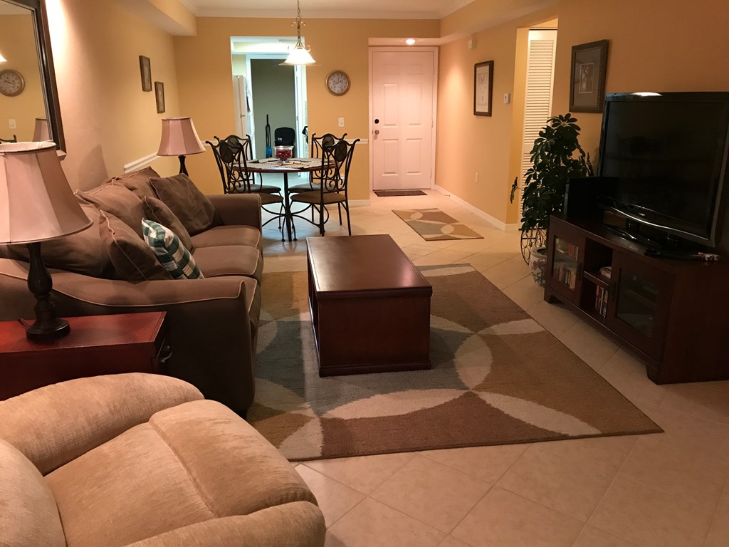 A living room with a couch, chair, and coffee table.