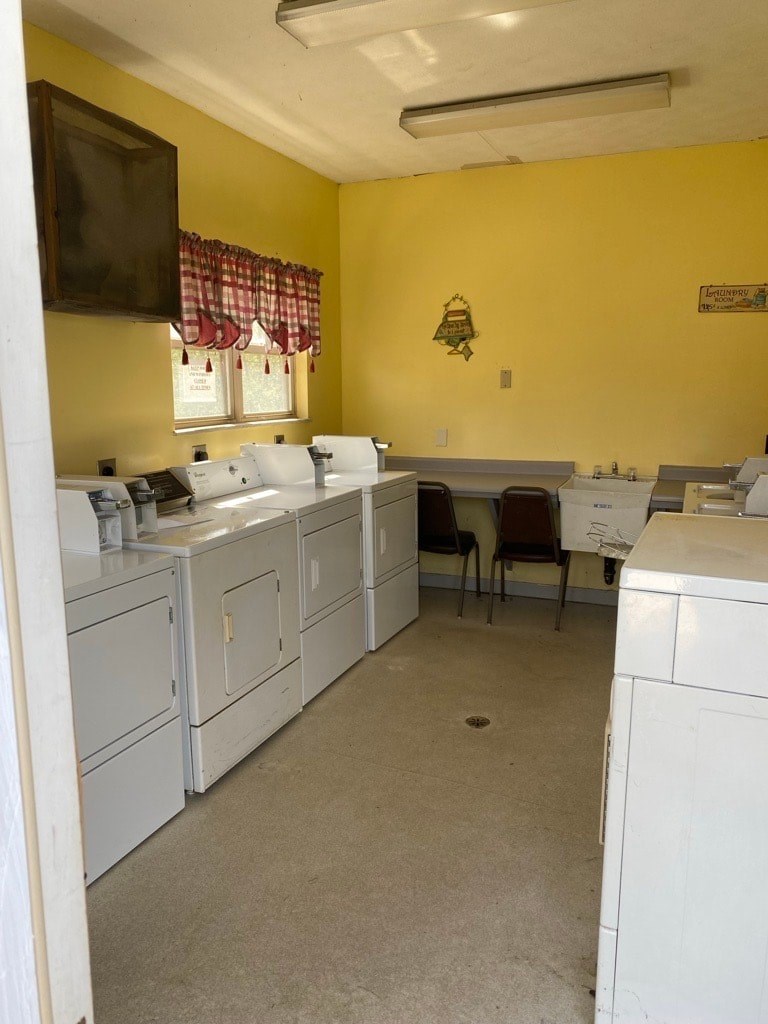 A yellow wall with a white counter and a brown clock.