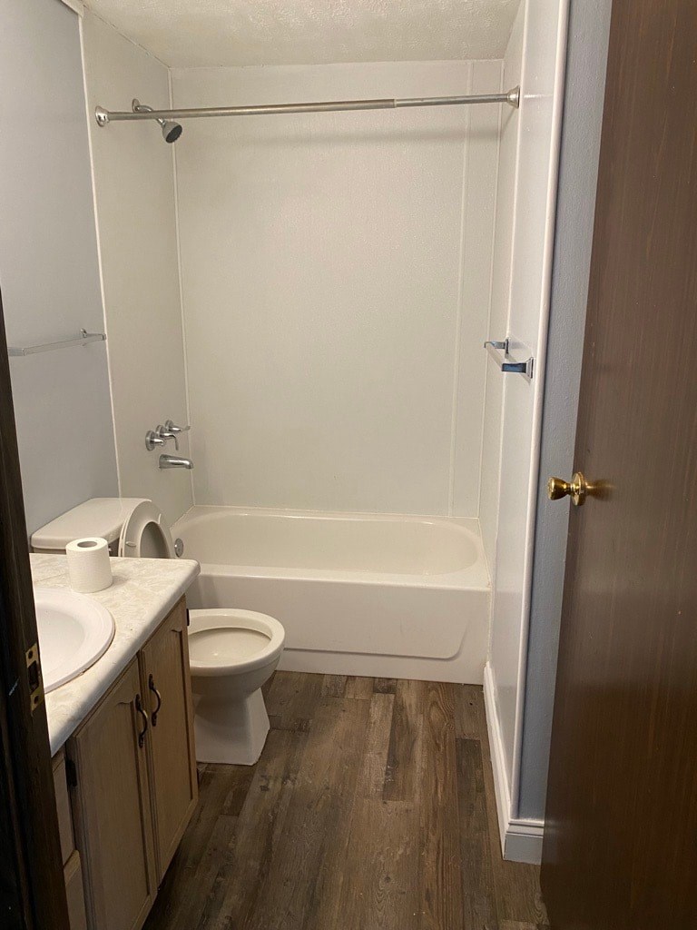A white bathroom with a toilet, sink, and bathtub.