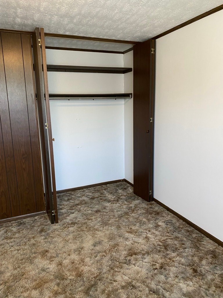 A room with a brown door and a white wall.