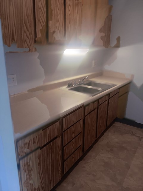A kitchen with wooden cabinets and a countertop.