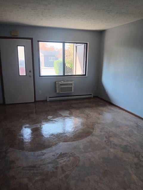 A room with a window and a door.