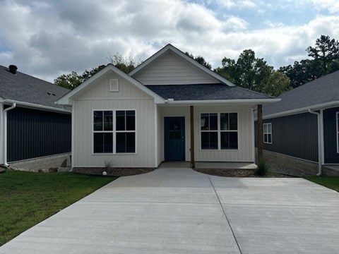 A house with a grey roof and a white door.