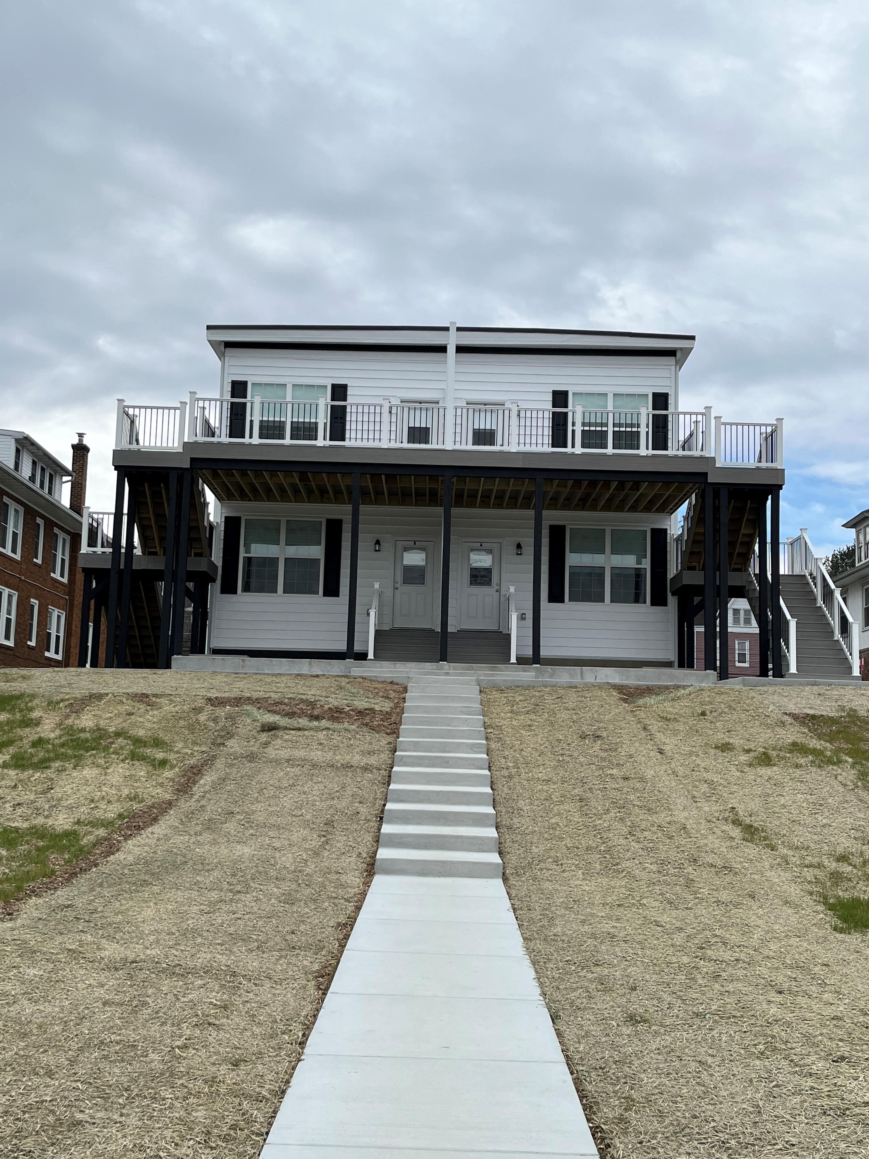A two-story house with a balcony on the second floor.