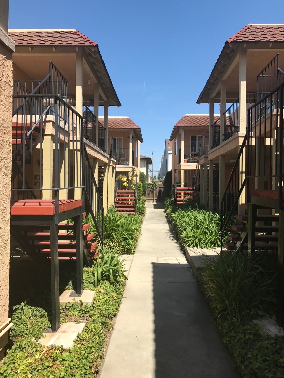A row of houses with red roofs and balconies.