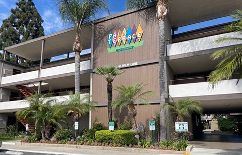 A building with a sign that says Palm Terrace.