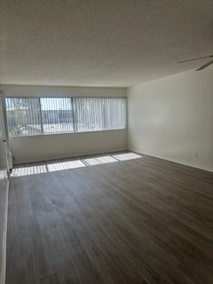 A room with a window and a wooden floor.