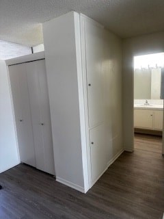 A white closet with a door and a mirror in the background.