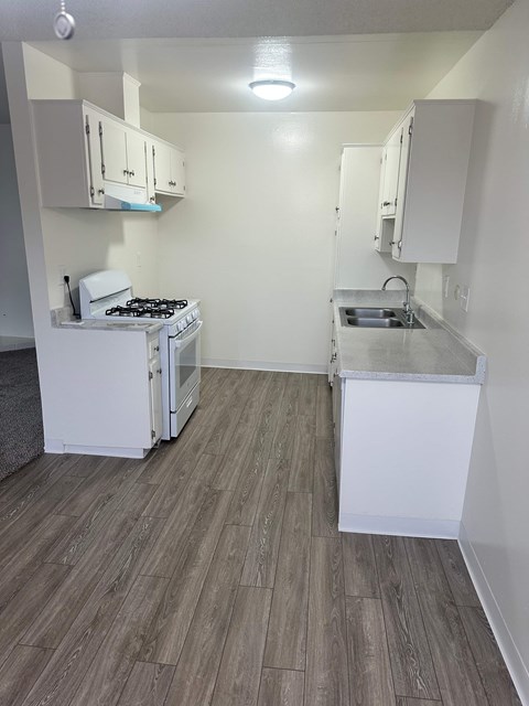 A small kitchen with a stove and sink.