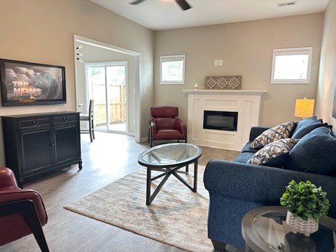 A living room with a fireplace, a couch, and a chair.