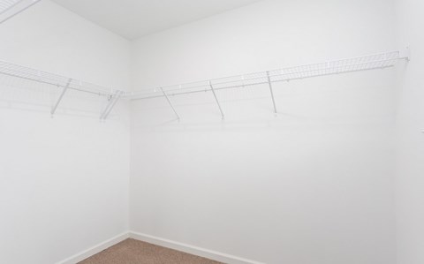 A white wall with a metal rack on it.