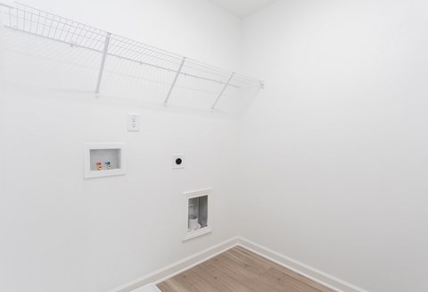 A white room with a fireplace and a picture on the wall.
