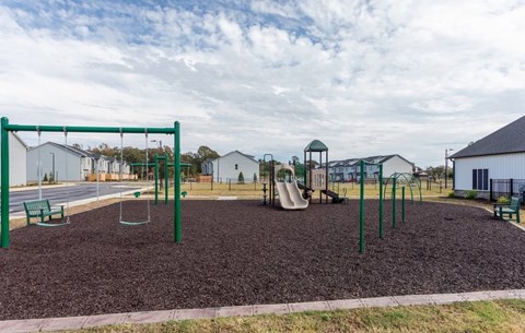 A playground with a swing set and a slide.