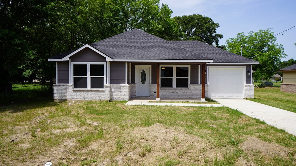 A small house with a grey roof and a white door.