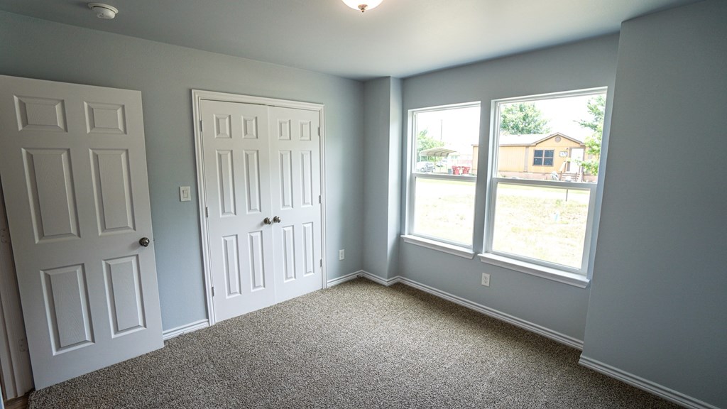 A room with two doors and a window.