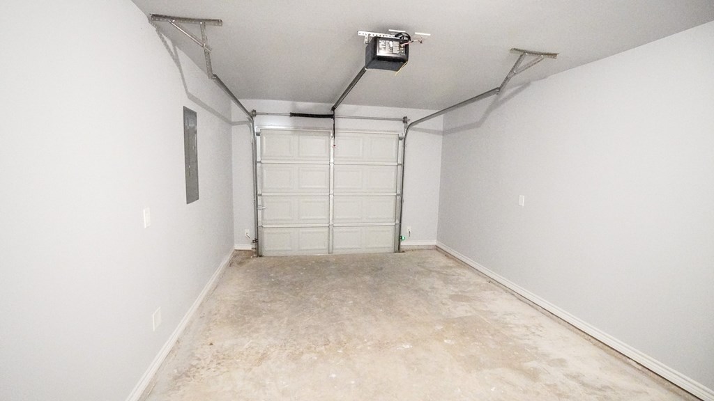 A room with a white wall and a white door.