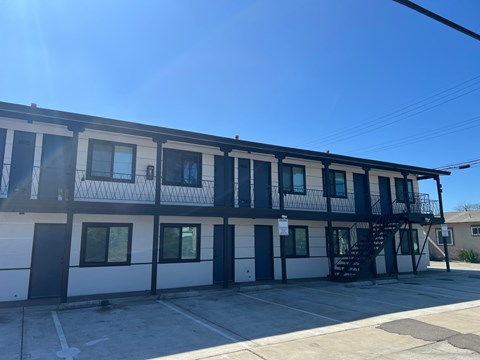 A white and black building with a black staircase.