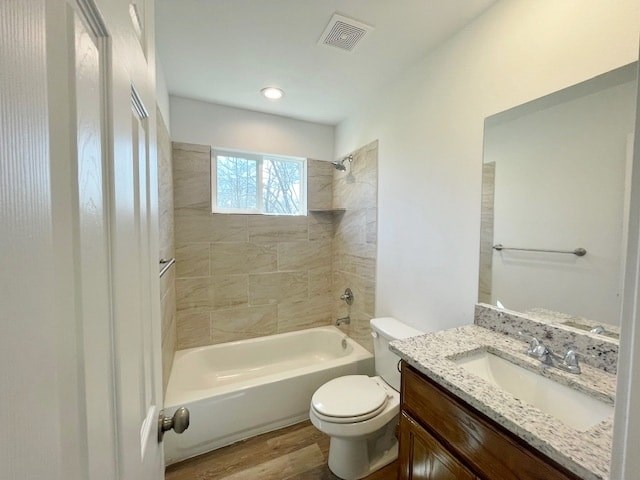 A bathroom with a tub, toilet, and sink.