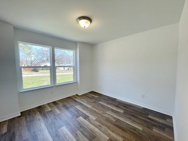 A room with a window and wooden flooring.