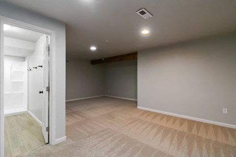 A room with a door on the left and a light on the ceiling.