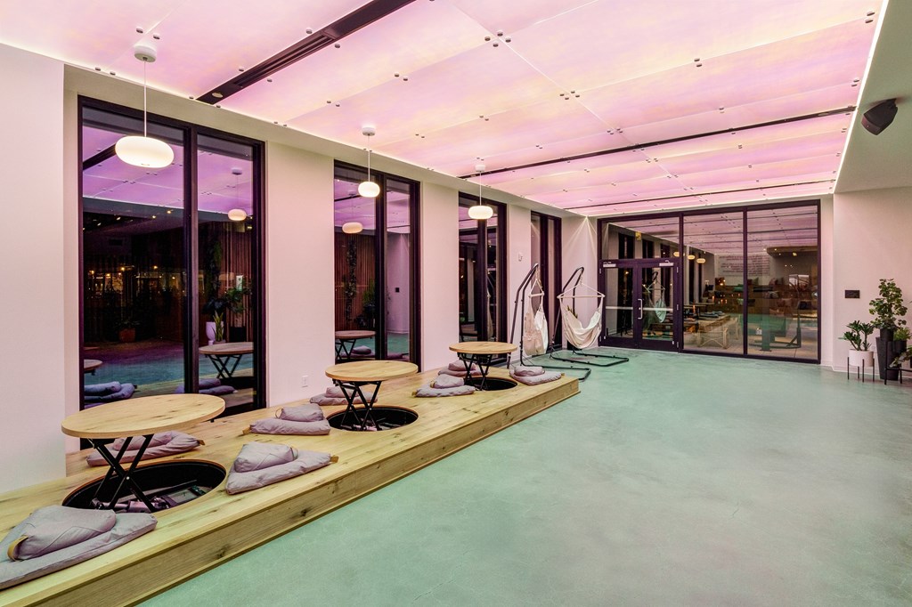 A modern room with a long table and chairs.