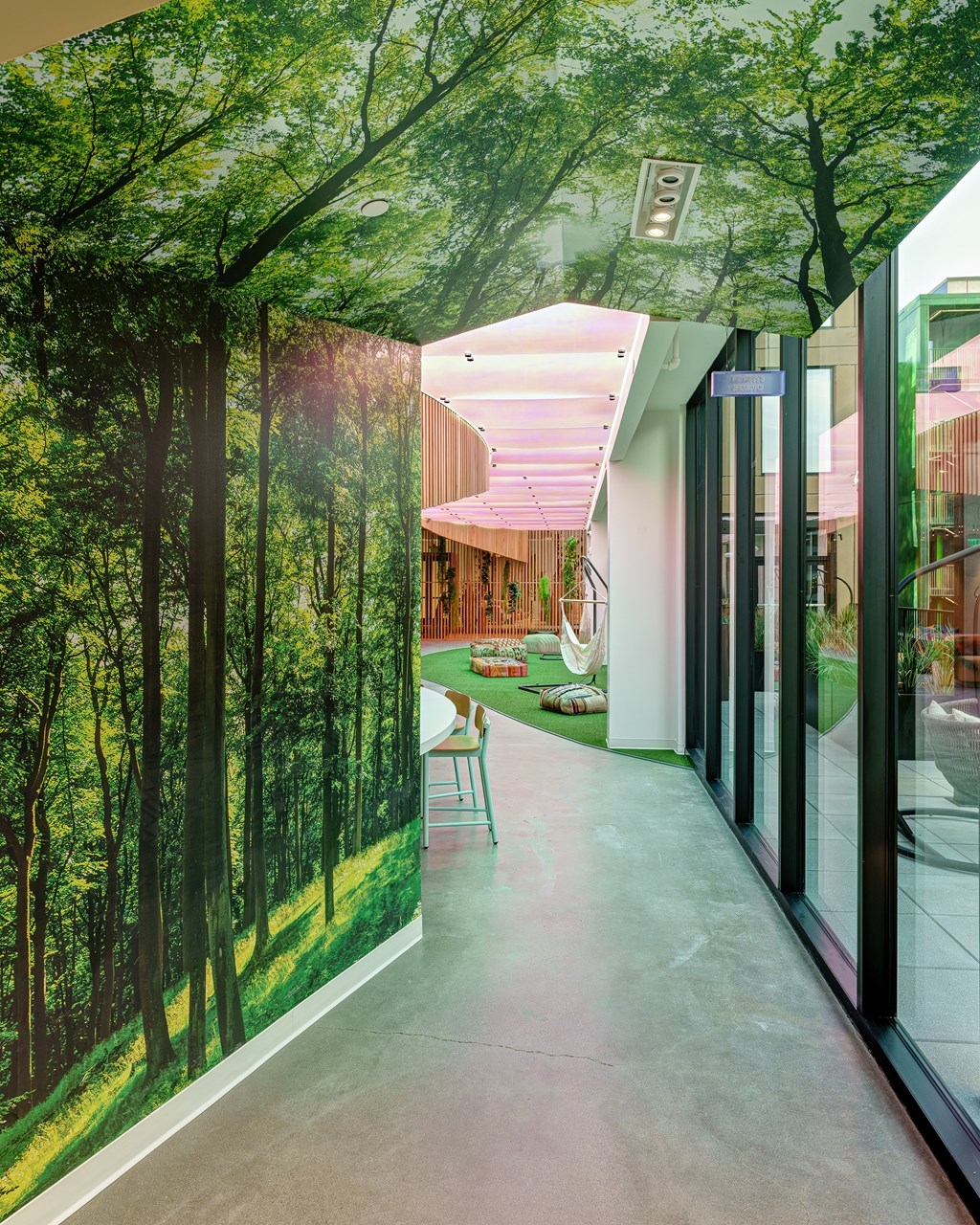A hallway with a mural of a forest on the wall.