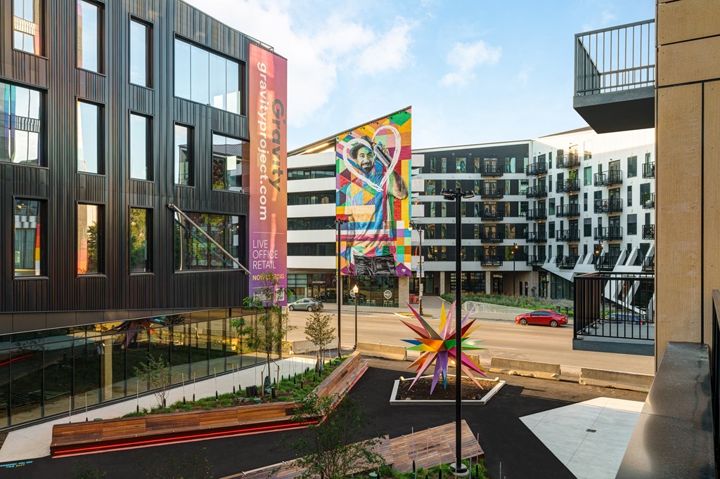 A colorful sculpture in the middle of a courtyard.
