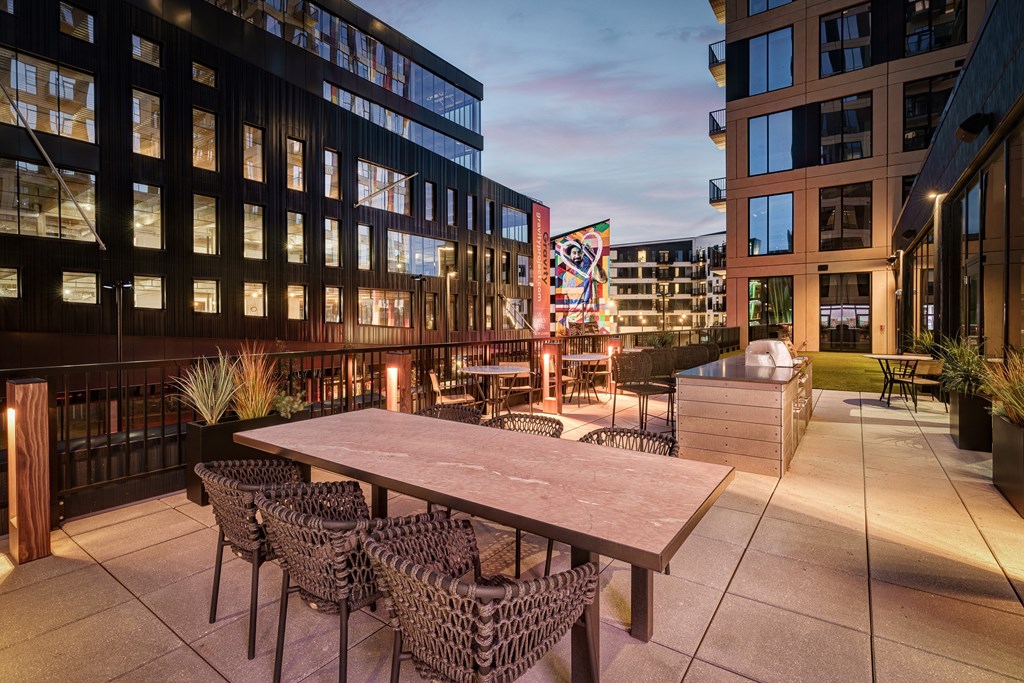 A patio with a table and chairs is set up outside a building.