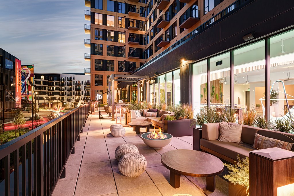 A patio with a fire pit and seating area.