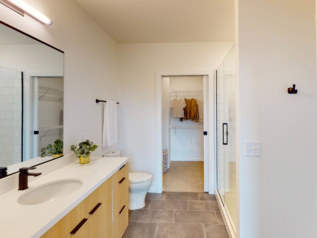 A bathroom with a white sink and a toilet.