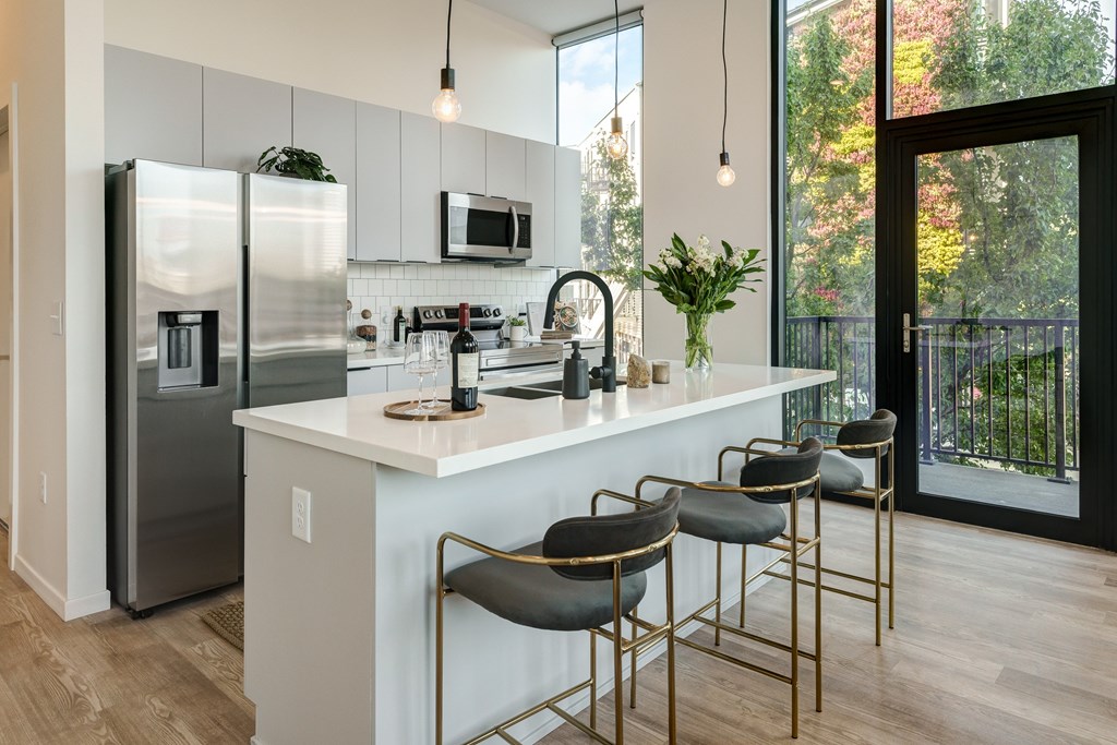 A kitchen with a white countertop and a refrigerator.