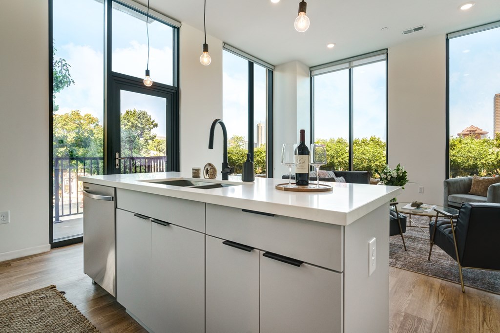 A modern kitchen with white cabinets and a large island.