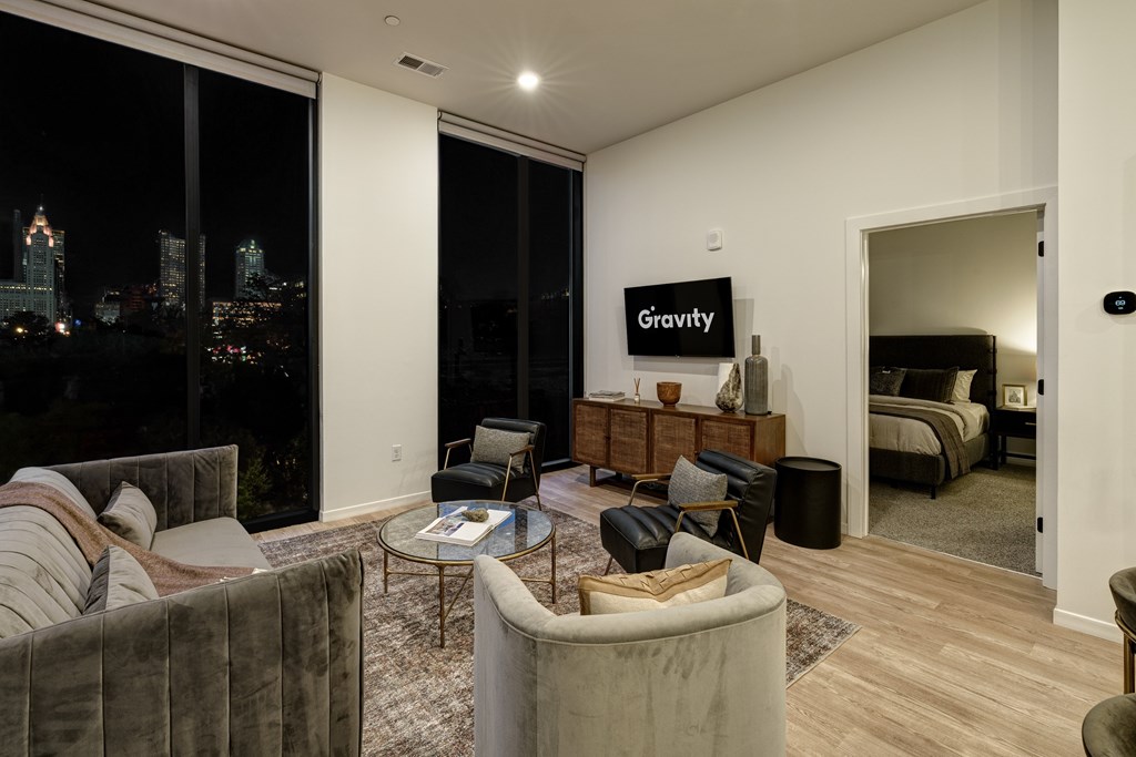 A living room with a Gravity sign on the wall.