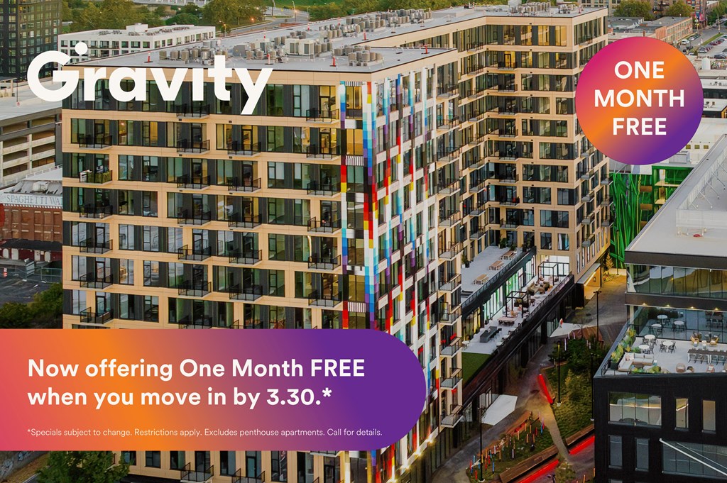 An advertisement for a one month free offer from Gravity, with a building in the background.