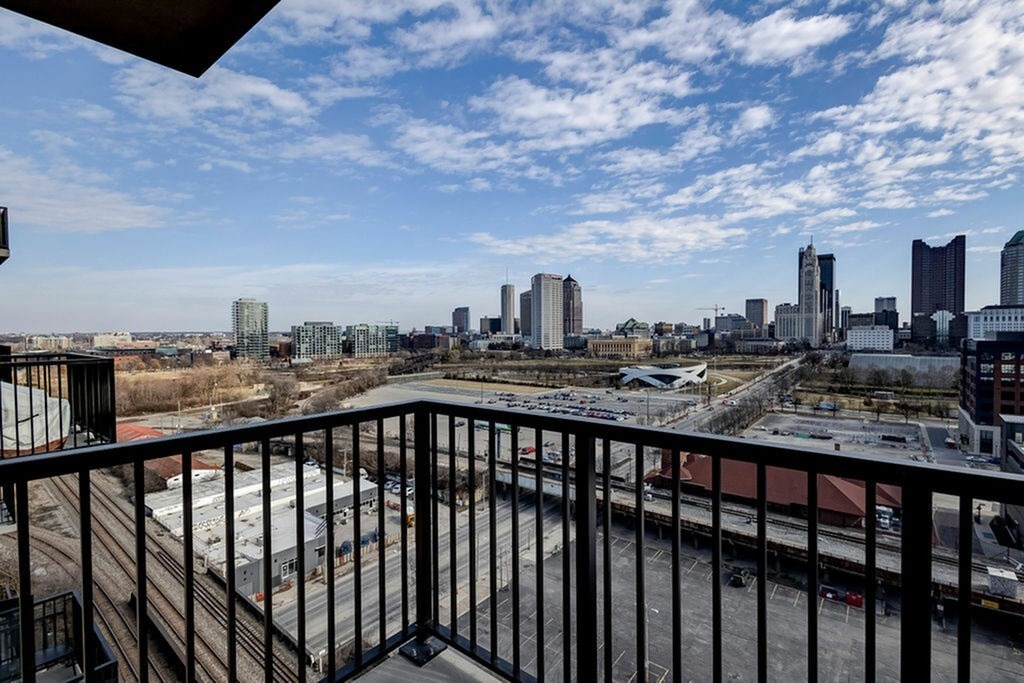 A cityscape viewed from a balcony.