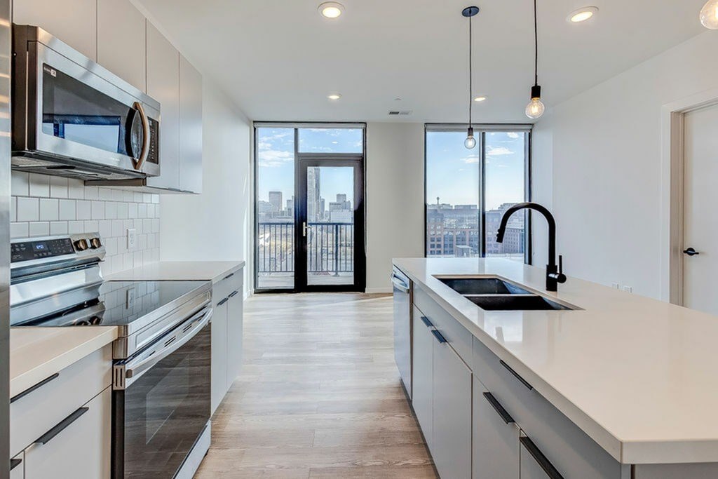 A modern kitchen with a view of the city.