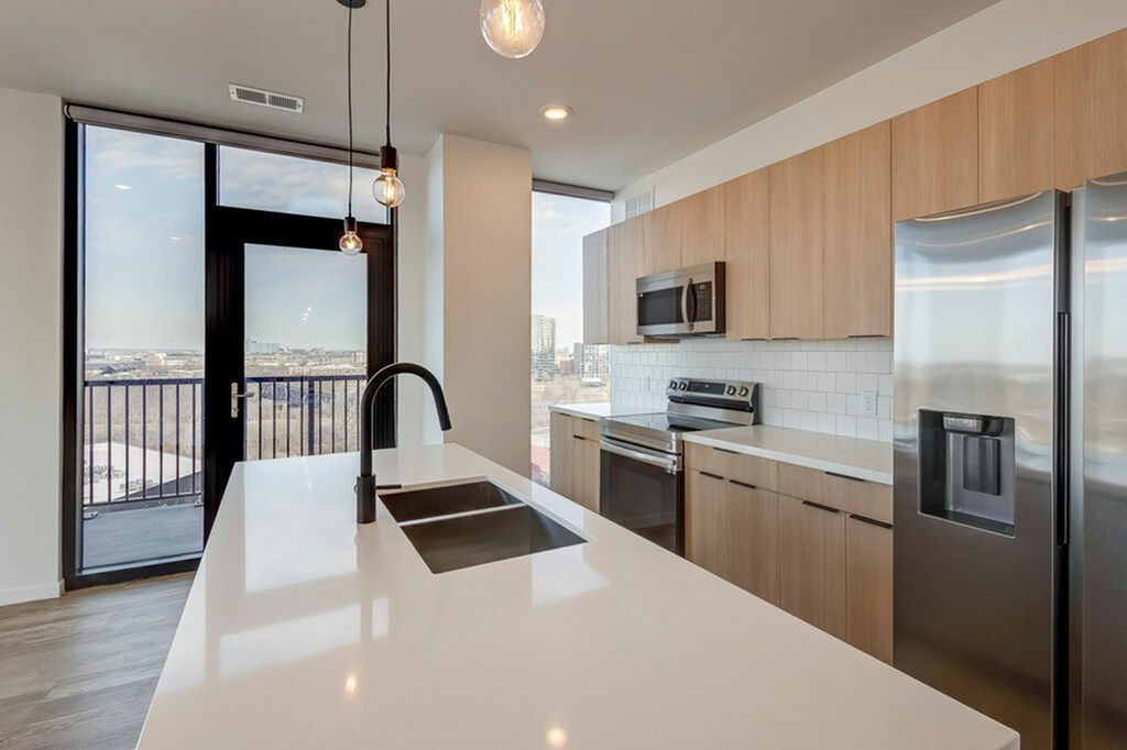 A modern kitchen with a view of the city.