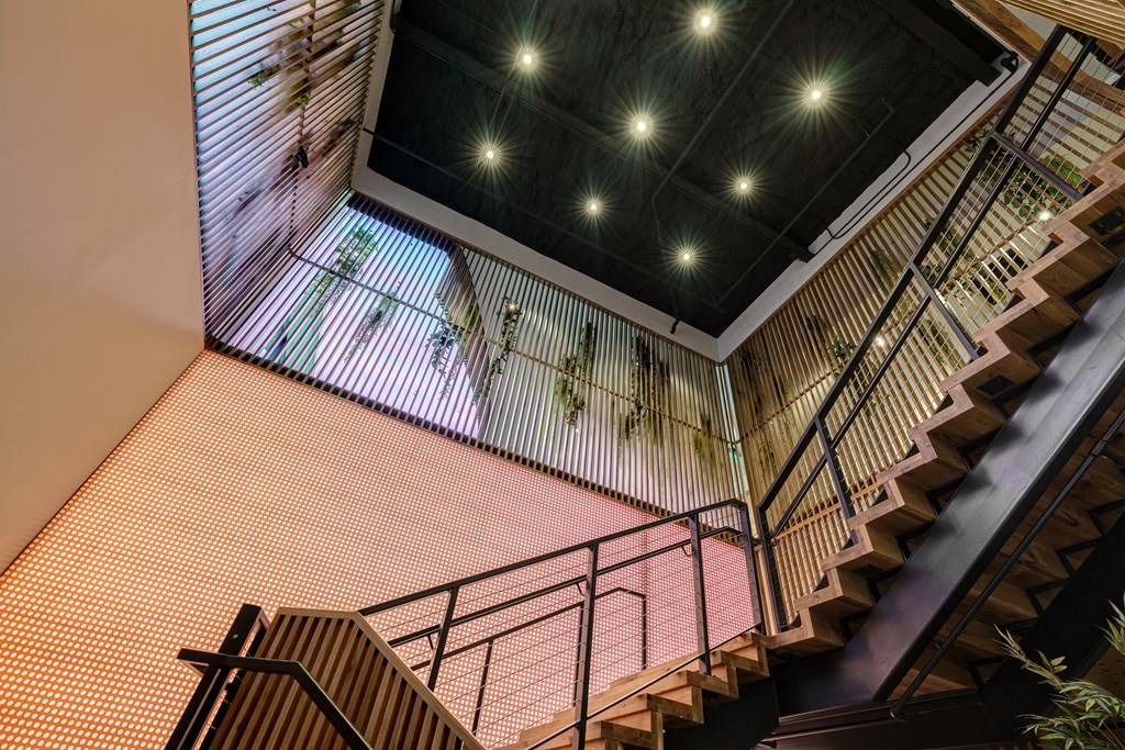 A staircase with a metal railing and wooden steps.