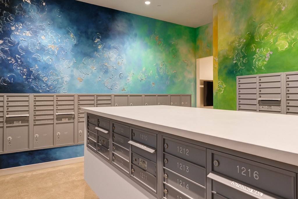 A row of mailboxes are lined up against a wall.