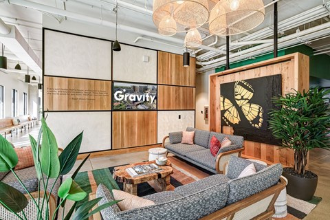 A modern living room with a grey sofa and a coffee table.
