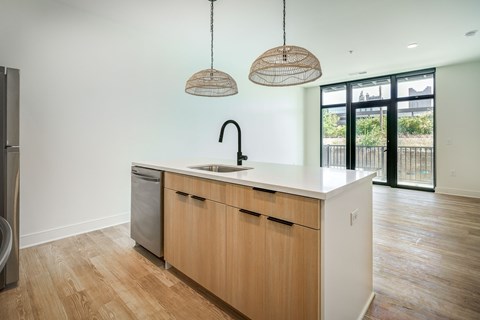 A kitchen with wooden cabinets and a white countertop.