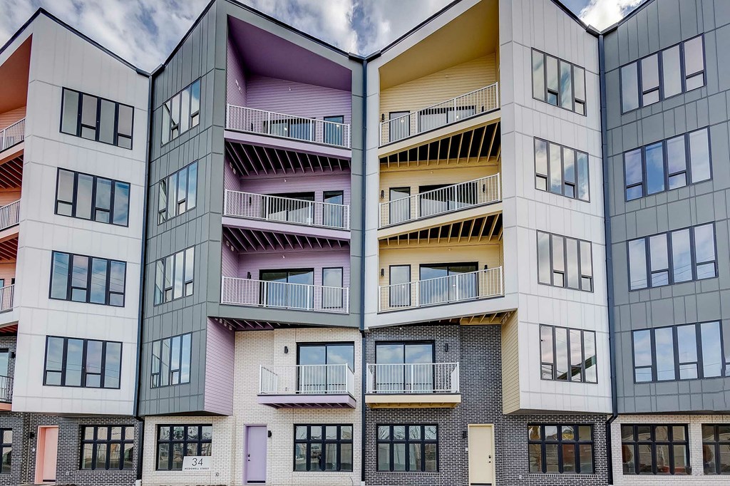 A modern apartment building with balconies and windows.