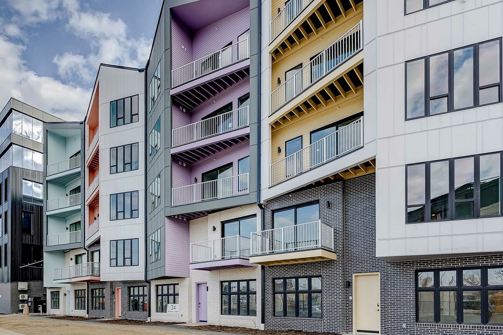 A modern apartment building with balconies and windows.
