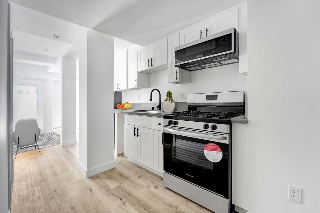 A modern kitchen with a stove and oven built into the wall.