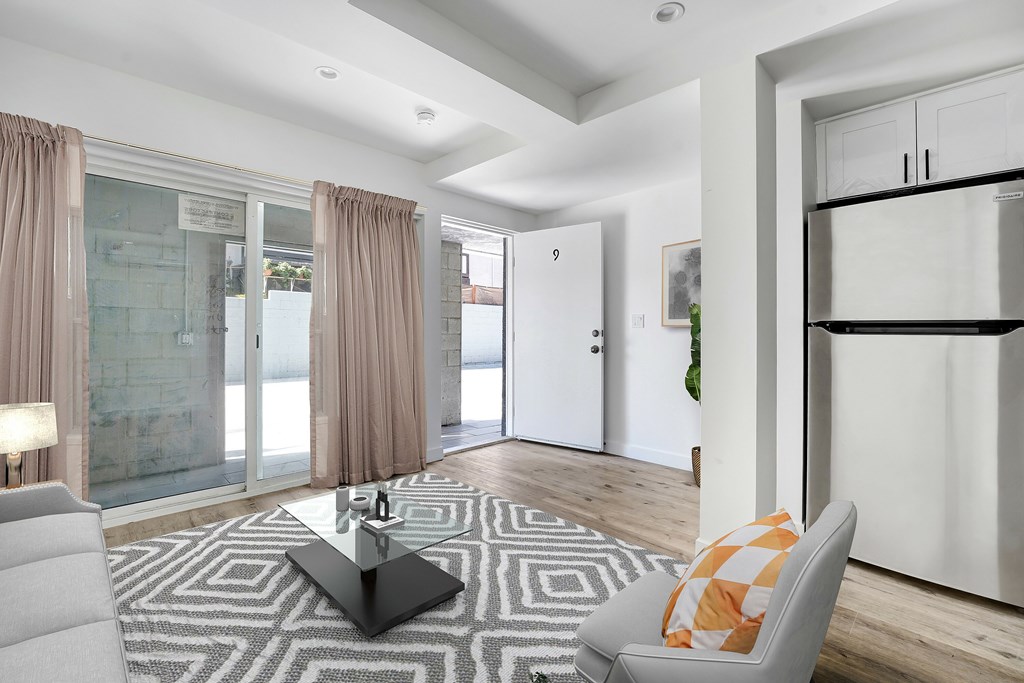 A modern living room with a grey sofa and a black coffee table.