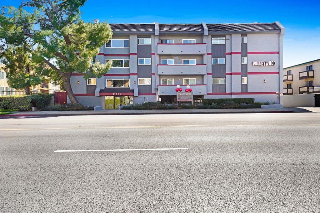 A large apartment building named Valleywood sits on a street corner.