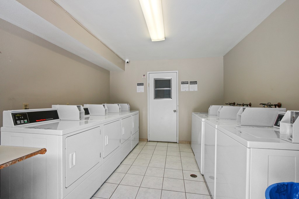 A laundry room with washers and dryers.