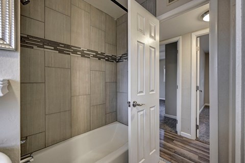 A white door is open to a hallway.