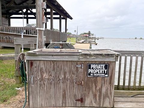 A wooden box with a sign that says Private Property No Trespassing.